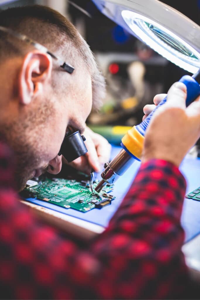 USB and Port Repair St Albans technician soldering a charging port on a board