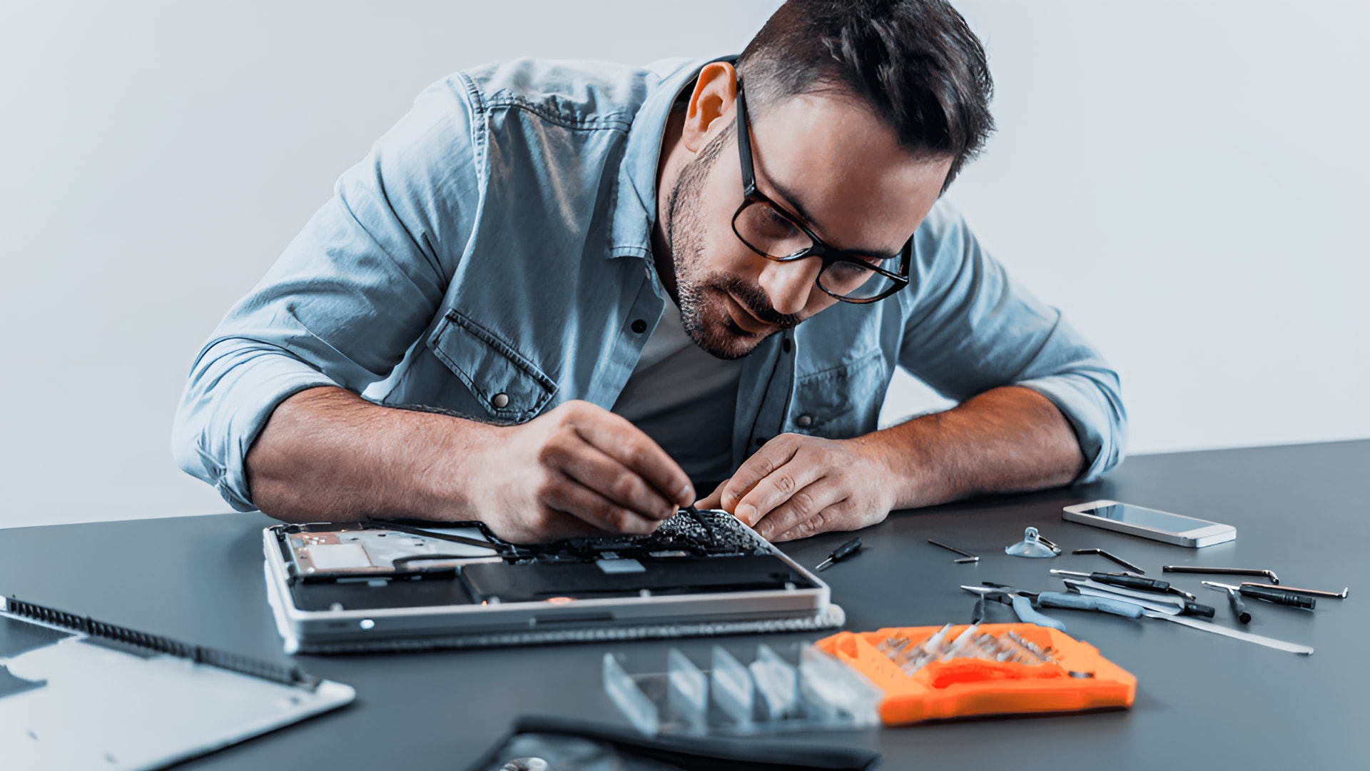 A person working on a laptop at a desk